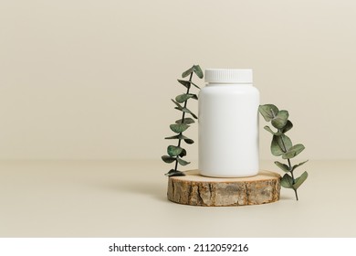 Medicine Bottle For Vitamins Or Pills On Wooden Podium With Eucalyptus Leaves, Natural Supplement, Organic Vitamins, Bottle Mockup, Copy Space