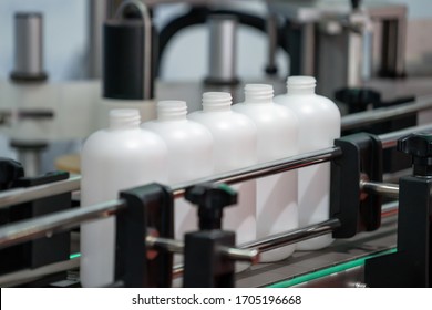Medicine bottles transfer on Conveyor Belt System. Industrial Machine for Pharmaceutical factory. Healthcare by industrail and technology concept.