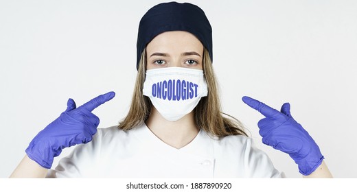 Medicine Concept. The Doctor Points His Fingers At The Mask With The Inscription - ONCOLOGIST