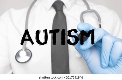 Medicine Concept. Doctor Writes The Word Autism . Image Of A Hand Holding A Marker Isolated On A White Background.