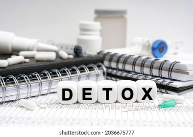 Medicine concept. On the table are diaries, medicines and cubes with the inscription - DETOX