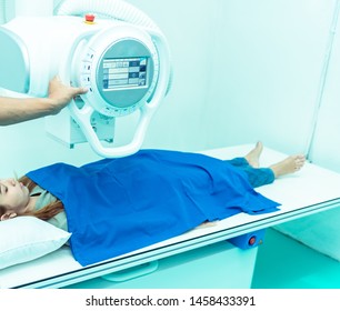 Medicine concept ,Technician Doctor male radiologist with colleague setting up machine to take female patient in x-ray room - Powered by Shutterstock