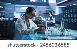 Medicine Development Laboratory: Asian Female Scientist Using Microscope, Analyzes Petri Dish Sample. Big Pharmaceutical Lab with Specialists Conducting Biotechnology Research, Developing New Drugs.