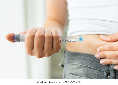 Medicine, Diabetes, Glycemia, Health Care And People Concept - Close Up Of Woman Hands Making Injection With Insulin Pen Or Syringe