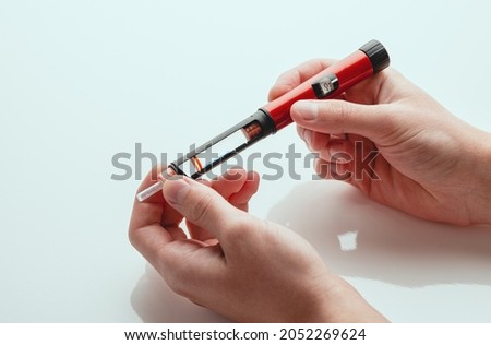 Medicine, diabetes, glycemia, healthcare and people concept - close-ups of man's hands. Medical devices are used for self-injection to treat diabetes. World Diabetes Day and the concept of health care