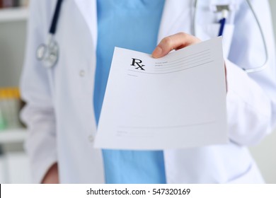 Medicine doctor hand giving prescription list to patient closeup. Healthcare, medical, prescribing treatment or legal drug store concept. Empty form ready to be used - Shutterstock ID 547320169