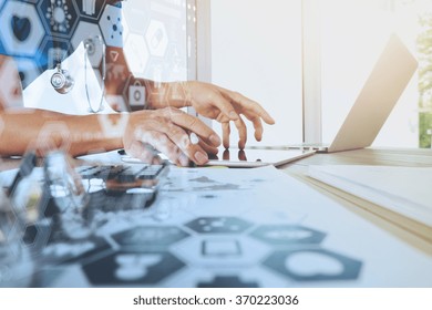 Medicine Doctor Hand Working With Modern Computer With Digital Health Care Diagram On Wooden Desk As Medical Concept

