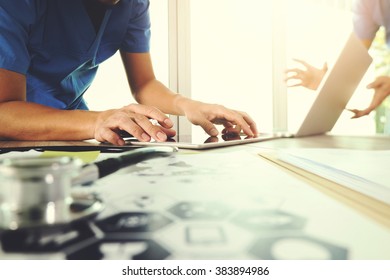 Medicine doctor hand working with modern computer and digital tablet  and diagram with his team on wooden desk as medical concept
                                - Shutterstock ID 383894986