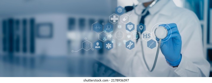 Medicine Doctor Holding A Stethoscope With Digital Medical Interface Icons, Medical Technology And Network Concept.