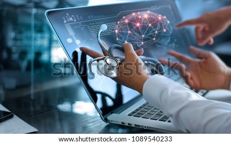 Medicine doctor team meeting and analysis. Diagnose checking brain testing result with modern virtual screen interface on laptop with stethoscope in hand, Medical technology network connection concept