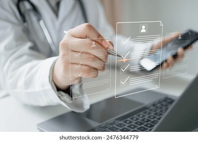 Medicine doctor use laptop to review patient medical records on virtual screens for digital healthcare. Review medical reports carefully and diagnose illnesses for an effective treatment plan. - Powered by Shutterstock