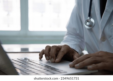 Medicine doctor working with computer notebook in the hospital. Physician input patient data and order some medicine online. - Powered by Shutterstock