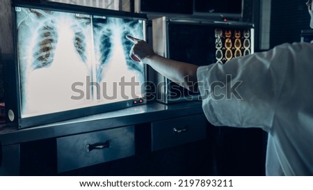 Medicine doctor working with a patients x-ray scans digital healthcare and connection.