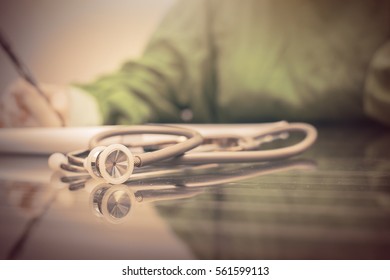 Medicine Doctor's Workingand Doctor Taking  Patient Notes With  And Stethoscope On  Table. Doctor Concept In Hotpital.Split Tone Instagram Like.With Light Processed.