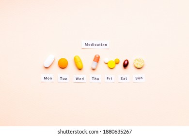 Medicine Drugs Daily And Weekly Schedule Concept. Above View. Drug Medication Reminder Conceptual. Pink Background. Outer Space.