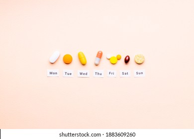Medicine Drugs Daily And Weekly Schedule Concept. Above View. Drug Medication Reminder Conceptual. Pink Background. Outer Space.
