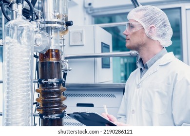 Medicine Factory Scientist Worker With Cannabis CBD Oil Extraction Machine. Hemp Oil Extraction Thin Film Distillation Laboratory Plants Process.