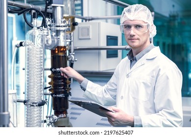 Medicine Factory Scientist Worker With Cannabis CBD Oil Extraction Machine. Hemp Oil Extraction Thin Film Distillation Laboratory Plants Process.