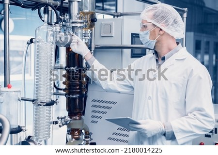 medicine factory scientist worker with Cannabis CBD oil extraction machine. Hemp oil extraction Thin Film Distillation Laboratory Plants Process.