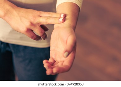 Medicine health care. Female hand checking pulse on wrist closeup. 
