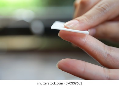 Medicine Health care and people concept - close up of female cleansing finger with alcohol before checking blood sugar level by Glucose meter on nature background
