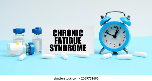 Medicine and health concept. An alarm clock, pills, injections and a card with the inscription - Chronic Fatigue Syndrome