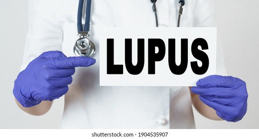 Medicine And Health Concept. The Doctor Points His Finger At A Sign That Says - LUPUS