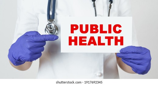 Medicine And Health Concept. The Doctor Points His Finger At A Sign That Says - PUBLIC HEALTH