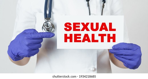 Medicine And Health Concept. The Doctor Points His Finger At A Sign That Says - SEXUAL HEALTH