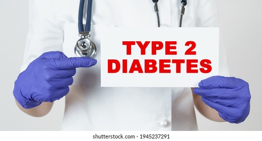 Medicine And Health Concept. The Doctor Points His Finger At A Sign That Says - TYPE 2 DIABETES