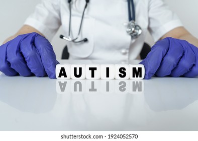 Medicine And Health Concept. The Doctor Put Together A Word From Cubes AUTISM