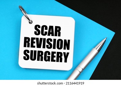 Medicine And Health Concept. On The Black Surface Lies Blue Paper, A Pen And A Notebook With The Inscription - Scar Revision Surgery