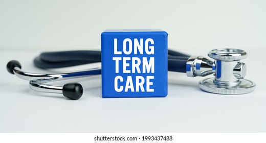 Medicine and health concept. On the table is a stethoscope and a blue cube with the inscription - LONG TERM CARE - Shutterstock ID 1993437488