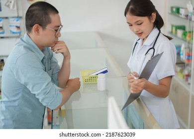 Medicine And Health Concept, Pharmacist Explain Prescription And Side Effect Of Medicine To Client.