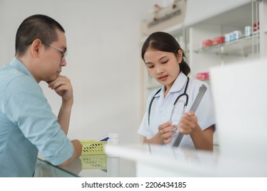 Medicine And Health Concept, Pharmacist Explain Prescription And Side Effect Of Medicine To Client.