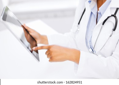 medicine, health and hospital concept - close up of female doctor working with tablet pc