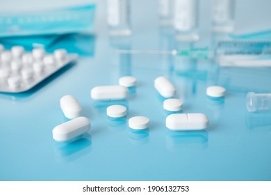 Medicine, health, treatment, pharmacy concept. Medical background. white tablets, syringe for injection