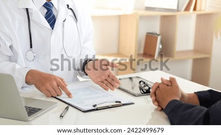 Medicine and healthcare concept. doctor and patient discussing current health examination while sitting in clinic. Medical care, insurance, prescription, paper work. annual physical examination. 