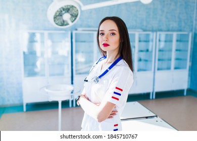 Medicine And Healthcare Concept. Female Doctor Surgeon Working At Surgery Room And Smiling At Camera