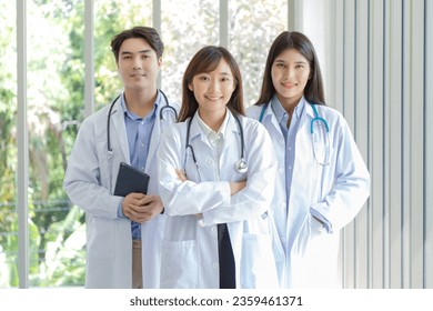 Medicine and healthcare concept : Group of happy and cheerful asian doctors Line up, Male and Female are smiling in lobby of hospital. COPY SPACE. - Powered by Shutterstock