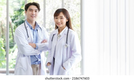 Medicine and healthcare concept : Happy and cheerful asian doctors, Male and Female posing cross arms with stethoscope and smiling in lobby of hospital. - Shutterstock ID 2186747603