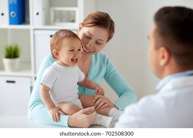 Medicine, Healthcare, Pediatry And People Concept - Happy Woman With Baby And Doctor At Clinic