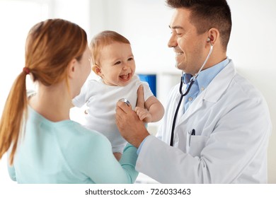 medicine, healthcare, pediatry and people concept - happy doctor with stethoscope listening to baby on medical exam at clinic