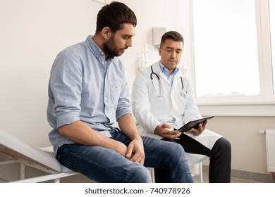 medicine, healthcare and people concept - doctor with clipboard and young male patient having health problem meeting at hospital - Shutterstock ID 740978926