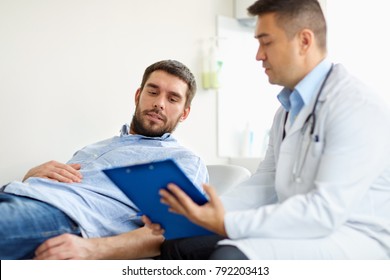 medicine, healthcare and people concept - doctor with clipboard and young male patient having health problem meeting at hospital - Shutterstock ID 792203413