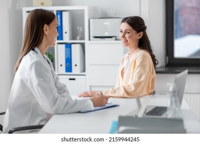 medicine, healthcare and people concept - female doctor with clipboard talking to smiling woman patient at hospital - Shutterstock ID 2159944245