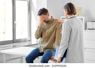 Medicine, Healthcare And People Concept - Female Doctor With Clipboard And Sad Male Patient Having Health Problem At Hospital