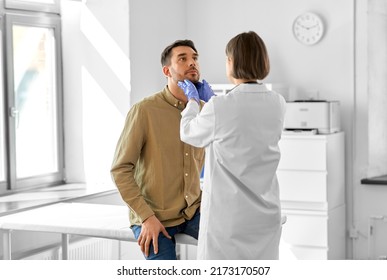 medicine, healthcare and people concept - female doctor checking lymph nodes of man patient at hospital - Shutterstock ID 2173170507