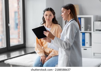 medicine, healthcare and people concept - female doctor with tablet pc computer talking to woman patient at hospital - Shutterstock ID 2188588637