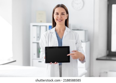 Medicine, Healthcare And Profession Concept - Smiling Female Doctor Showing Tablet Pc Computer With Empty Screen At Hospital